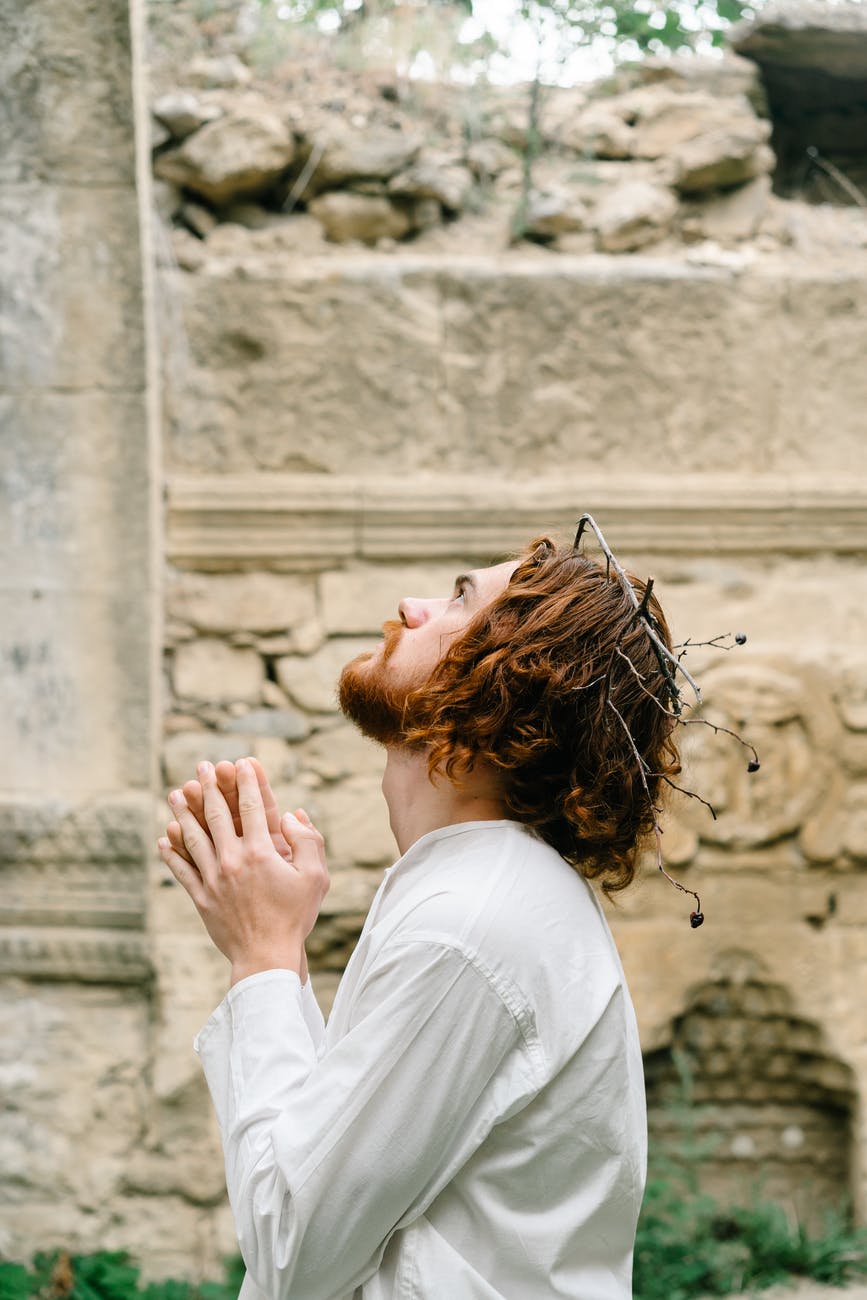 woman in white shirt covering her face with her hair
